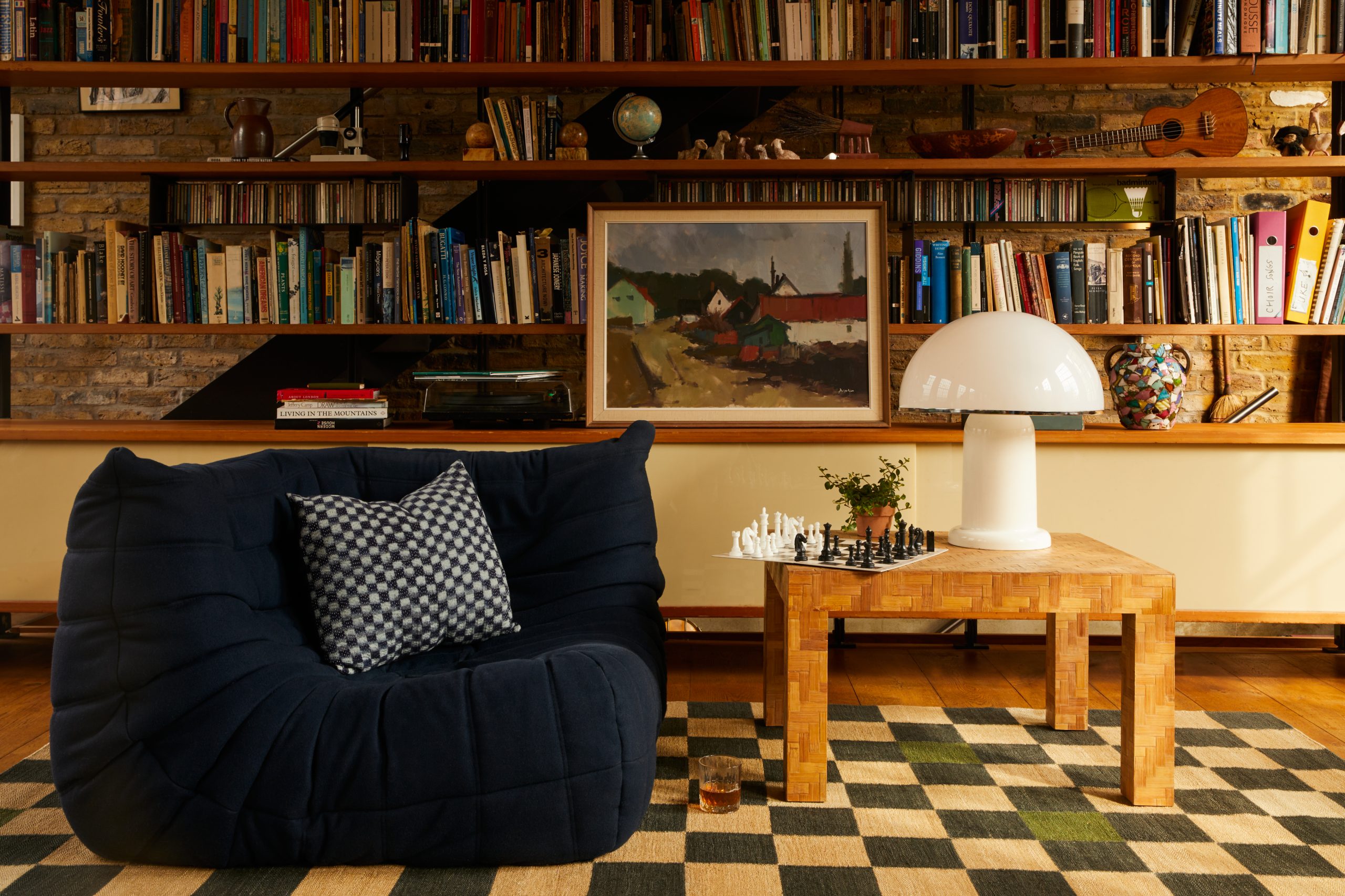 A mushroom lapm on a side table next to a Ligne Roset Togo Sofa.