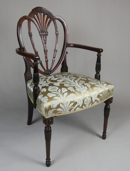 A mahogany wood shield-back dining chair with upholstered seat and arm rests.