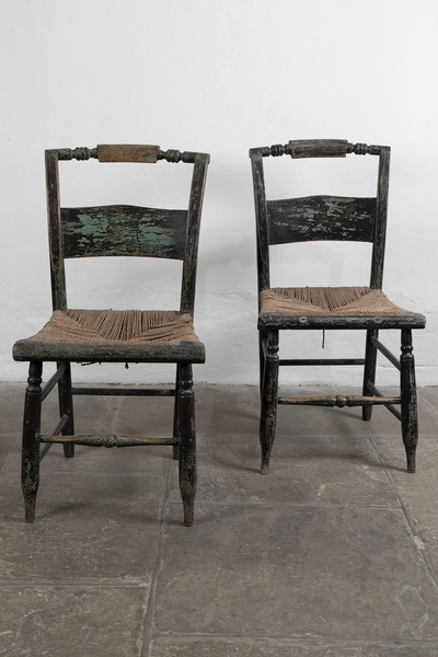A pair of Lambert Hitchcock chairs with rush woven seats.