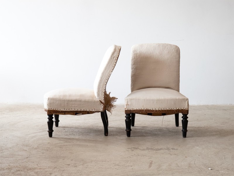 A pair of stripped back antique French Slipper chairs. One front view, one side view.